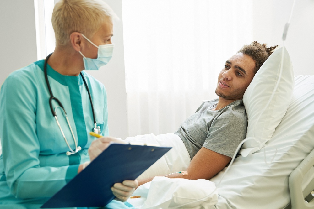 medical-practitioner-speaking-to-patient-while-tak-2023-02-02-00-56-07-utc-1