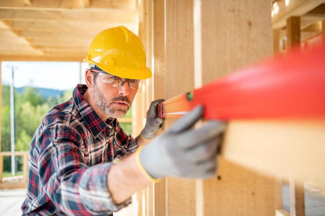 worker-using-level-tool-measure-frame-house-constr-2021-08-28-15-56-12-utc-1